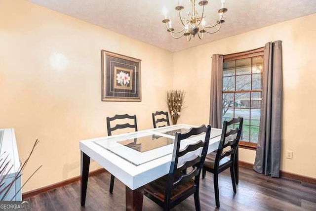 dining area featuring dark wood finished floors, baseboards, and a chandelier