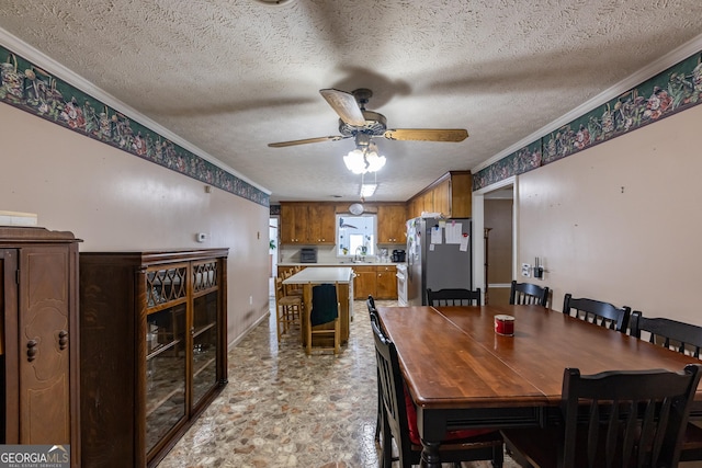 dining room with crown molding, a ceiling fan, baseboards, and a textured ceiling