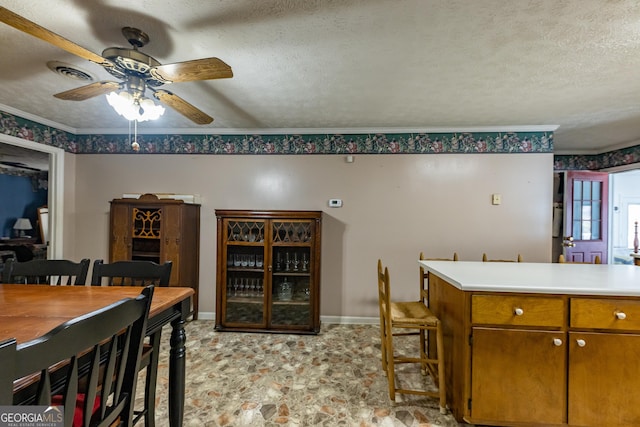 interior space with crown molding, baseboards, visible vents, and a textured ceiling