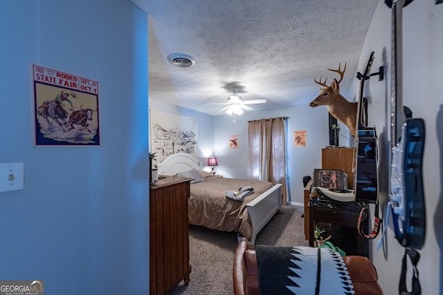 bedroom with visible vents, a textured ceiling, a ceiling fan, and dark colored carpet