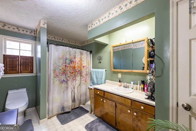 full bath with vanity, a shower with curtain, a textured ceiling, tile patterned floors, and toilet