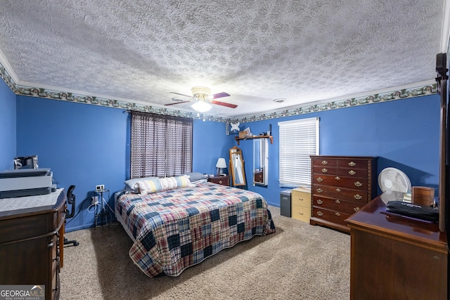 carpeted bedroom with a textured ceiling, ceiling fan, and crown molding