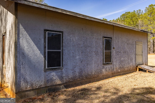 view of side of home featuring stucco siding