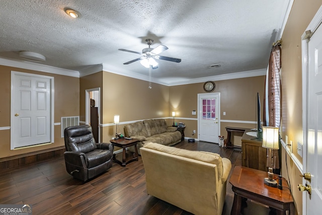 living room featuring visible vents, dark wood-type flooring, crown molding, and a textured ceiling