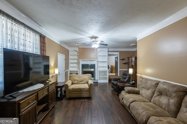 living room featuring a ceiling fan, a textured ceiling, dark wood finished floors, a high end fireplace, and crown molding