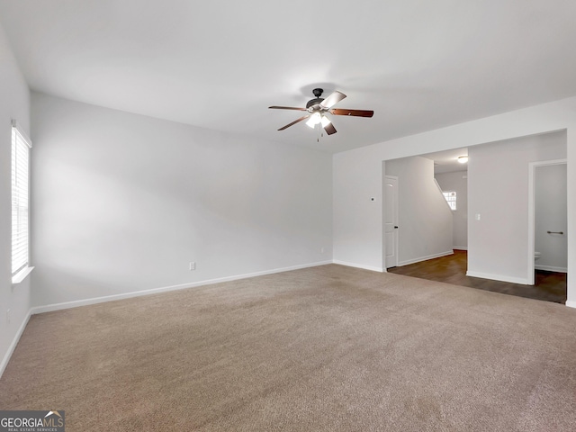 spare room with baseboards, a healthy amount of sunlight, ceiling fan, and carpet flooring