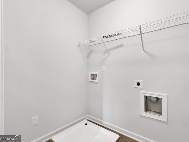 laundry room featuring electric dryer hookup, baseboards, hookup for a washing machine, and laundry area