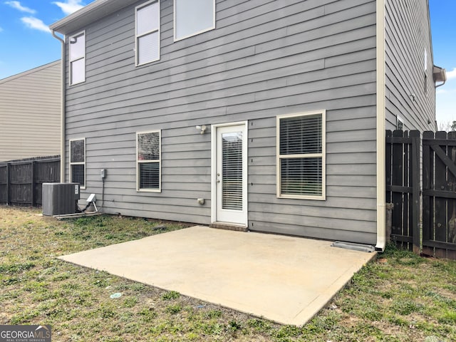 back of property with a patio area, central AC, and fence