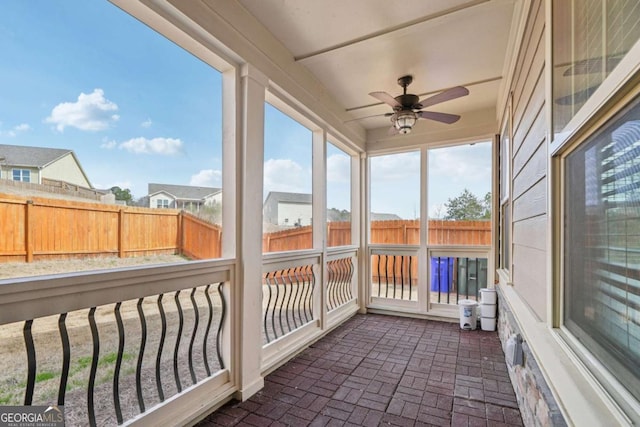 sunroom / solarium with a ceiling fan