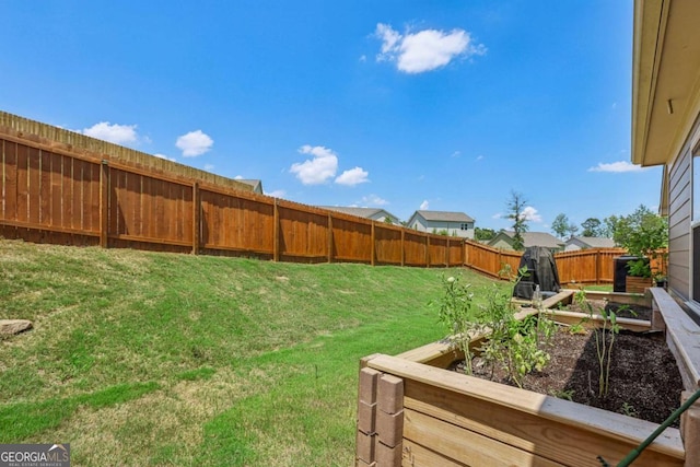 view of yard with a vegetable garden and fence