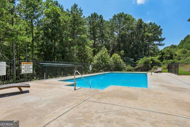 pool featuring a patio and fence