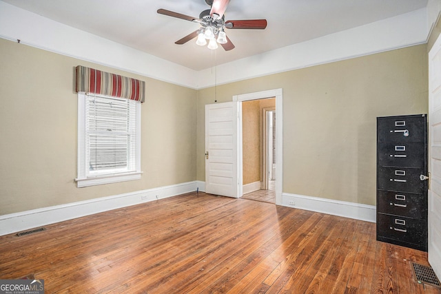 unfurnished bedroom with visible vents, wood-type flooring, baseboards, and ceiling fan