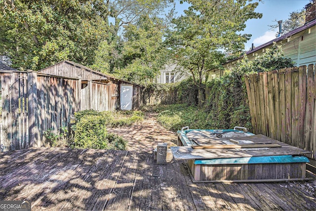 wooden deck with fence and a hot tub