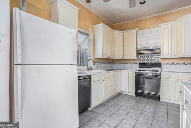 kitchen with range with gas stovetop, freestanding refrigerator, a sink, black dishwasher, and crown molding