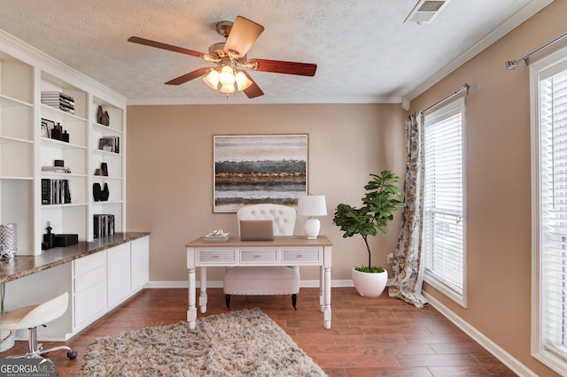 office featuring visible vents, a textured ceiling, wood finished floors, baseboards, and ceiling fan