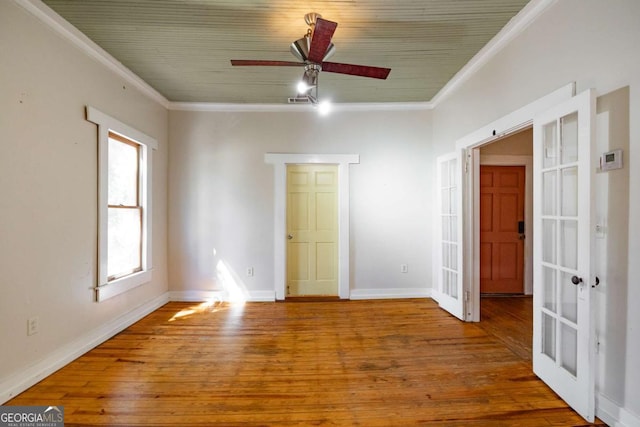 empty room featuring french doors, wood finished floors, baseboards, and ornamental molding