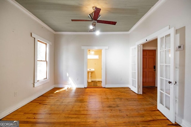 unfurnished room with ceiling fan, wood finished floors, french doors, and ornamental molding