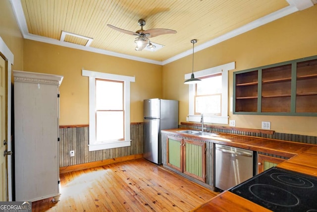 kitchen featuring visible vents, a wainscoted wall, dark countertops, appliances with stainless steel finishes, and light wood finished floors