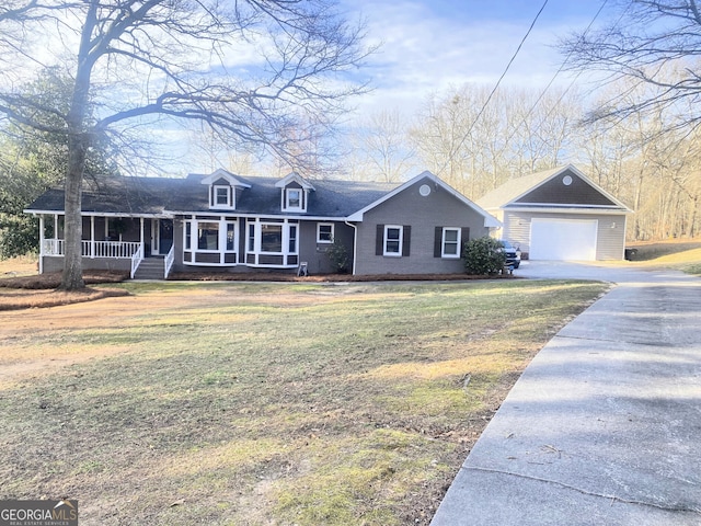 cape cod home with a detached garage, an outbuilding, covered porch, and a front yard