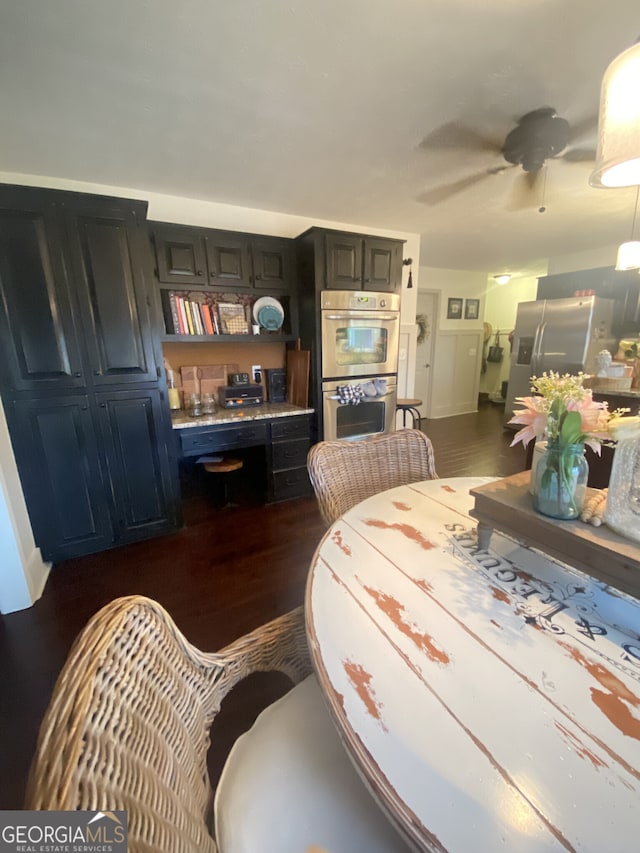 dining area with dark wood-type flooring and a ceiling fan