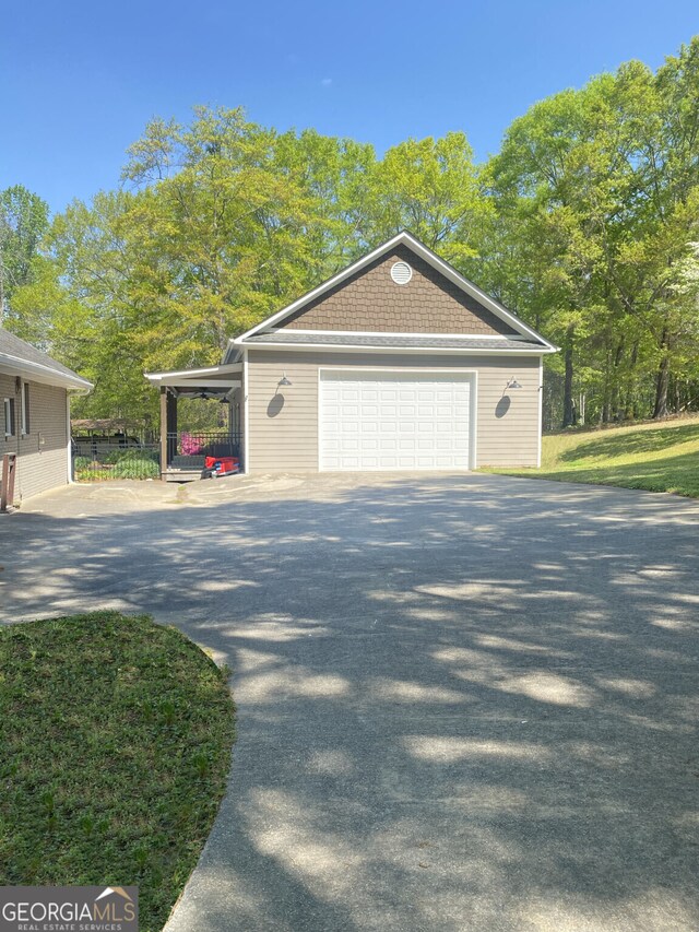 view of home's exterior featuring fence, a garage, and an outdoor structure