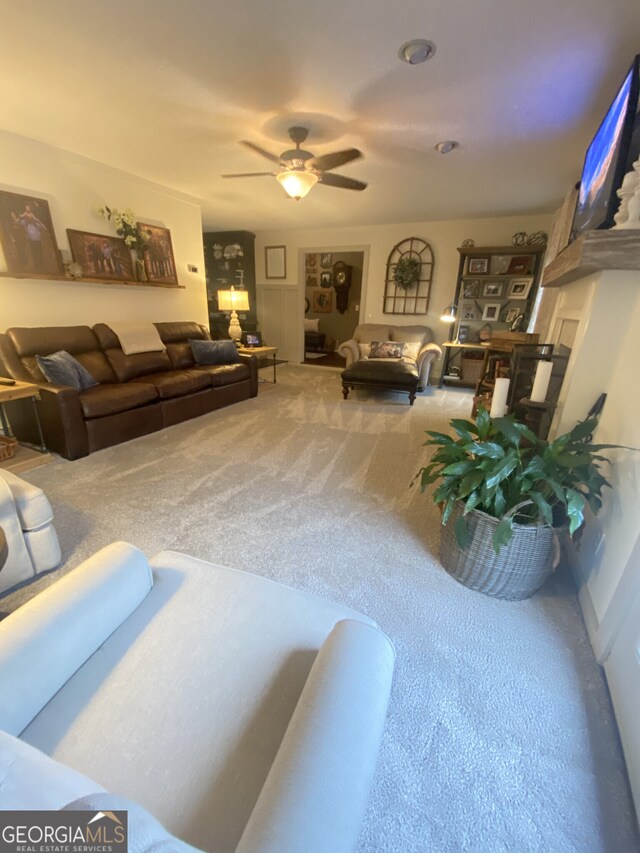 living room featuring carpet floors and a ceiling fan