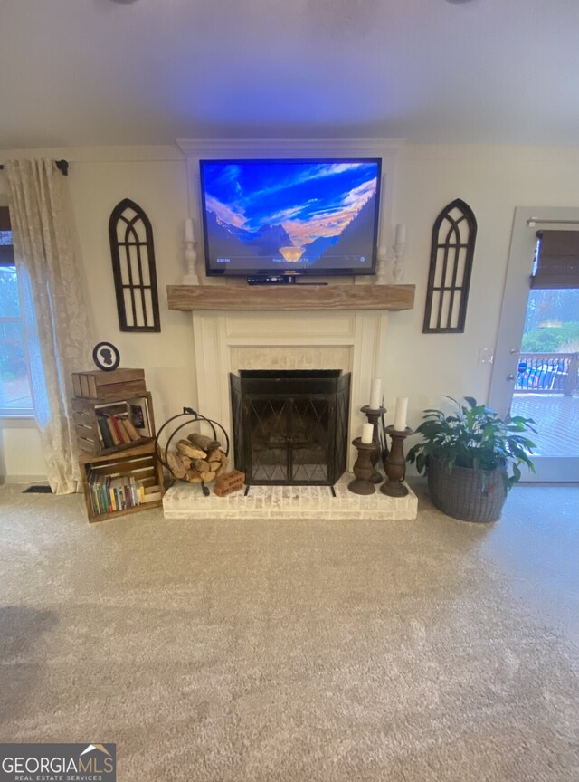 carpeted living area featuring a fireplace