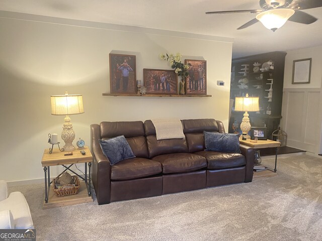 living room with carpet and a ceiling fan