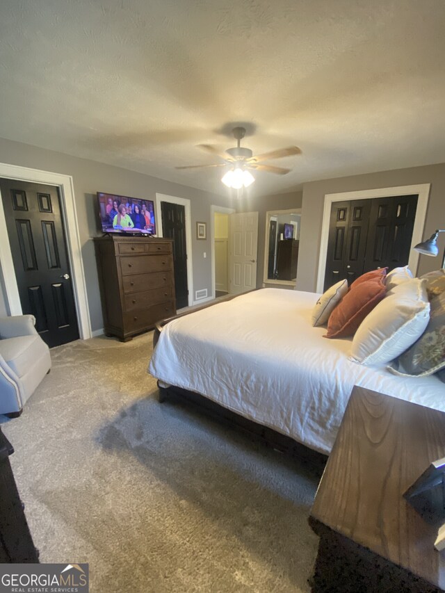 carpeted bedroom featuring baseboards and ceiling fan