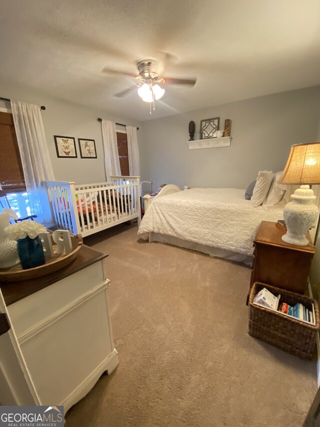 carpeted bedroom featuring a ceiling fan