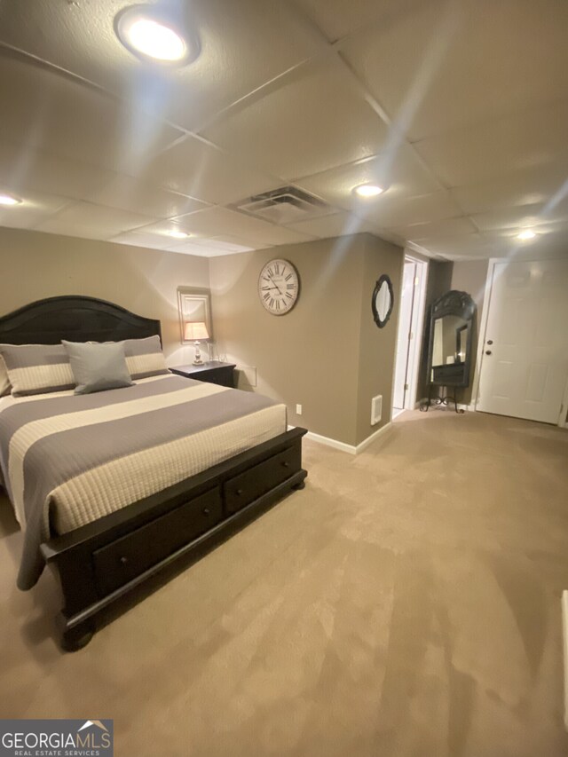 bedroom featuring light colored carpet and baseboards