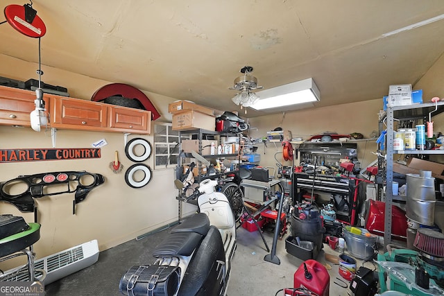 garage with a workshop area and ceiling fan