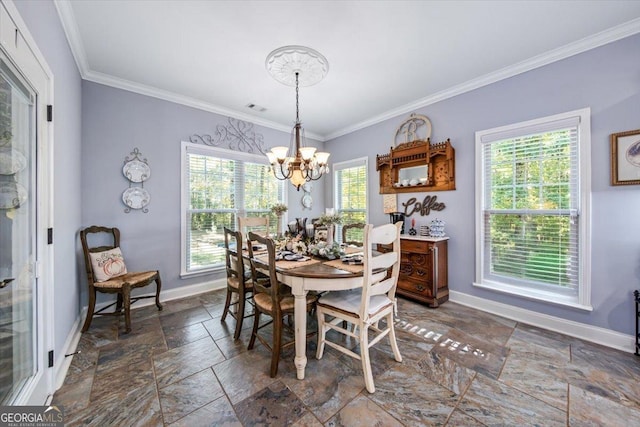 dining room featuring stone tile floors, an inviting chandelier, crown molding, and baseboards