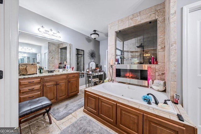 full bathroom featuring vanity, a fireplace, a whirlpool tub, and tiled shower