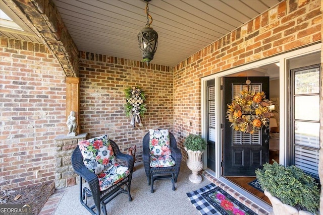 view of exterior entry featuring brick siding