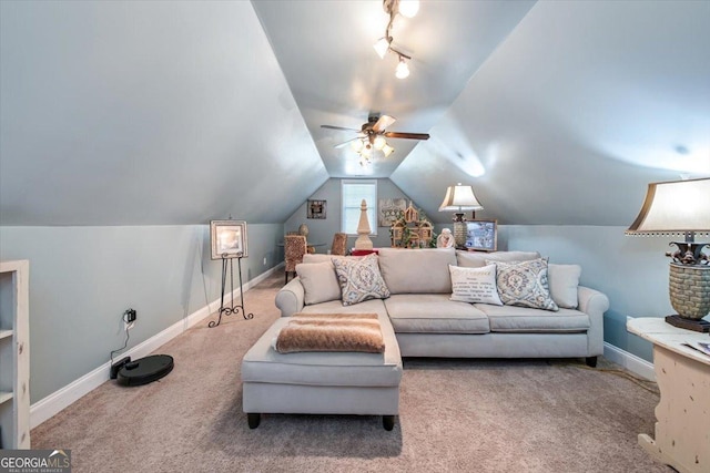 interior space with track lighting, ceiling fan, baseboards, vaulted ceiling, and carpet floors