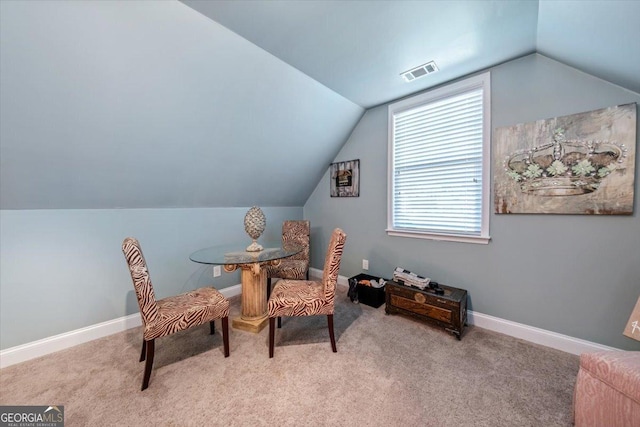 sitting room featuring vaulted ceiling, carpet flooring, baseboards, and visible vents