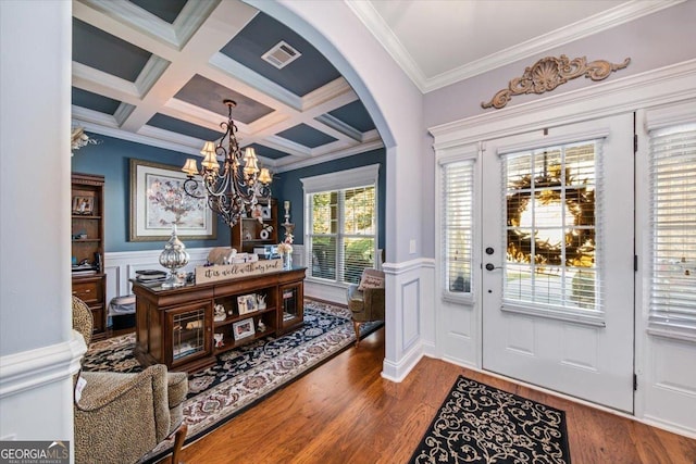 foyer entrance with visible vents, crown molding, wood finished floors, arched walkways, and coffered ceiling