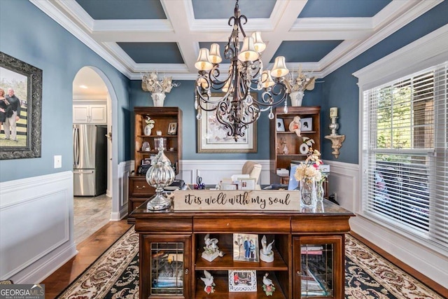 dining area featuring arched walkways, beam ceiling, crown molding, and a wainscoted wall