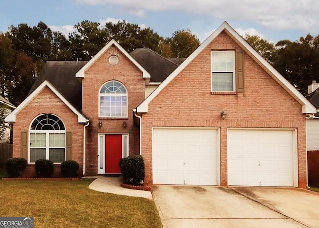 traditional home featuring brick siding, driveway, an attached garage, and a front lawn