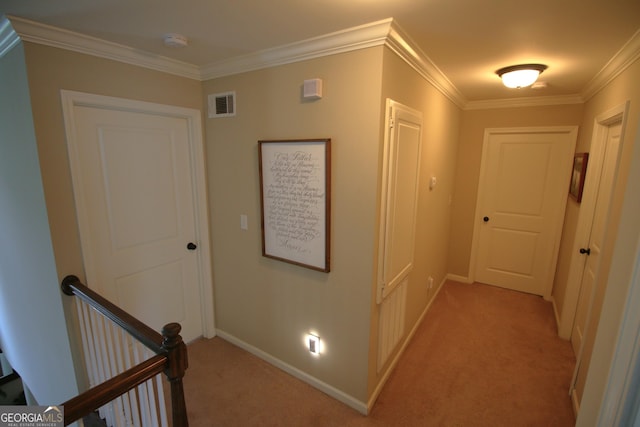 corridor with an upstairs landing, visible vents, light colored carpet, and ornamental molding