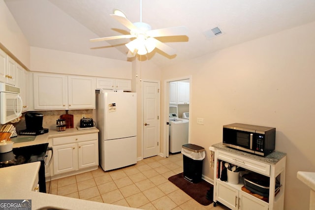 kitchen with visible vents, white appliances, separate washer and dryer, and white cabinetry