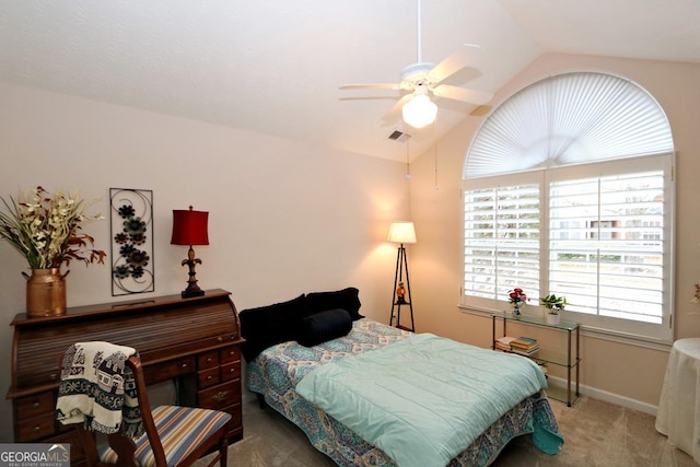 bedroom featuring visible vents, baseboards, carpet floors, vaulted ceiling, and a ceiling fan