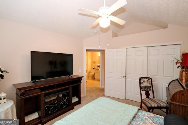 bedroom featuring a closet, light carpet, a ceiling fan, and vaulted ceiling