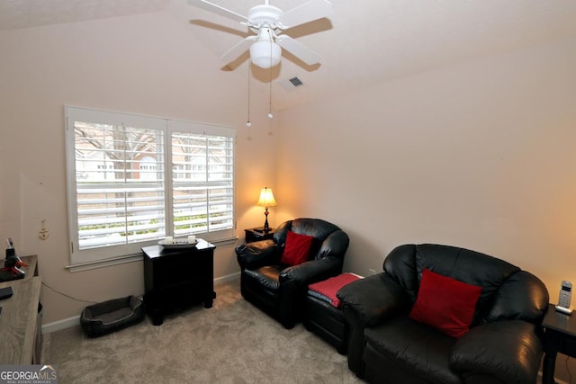 living area with visible vents, baseboards, carpet, and vaulted ceiling