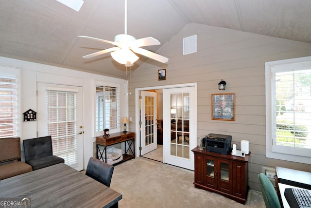 office featuring visible vents, lofted ceiling, ceiling fan, french doors, and light carpet