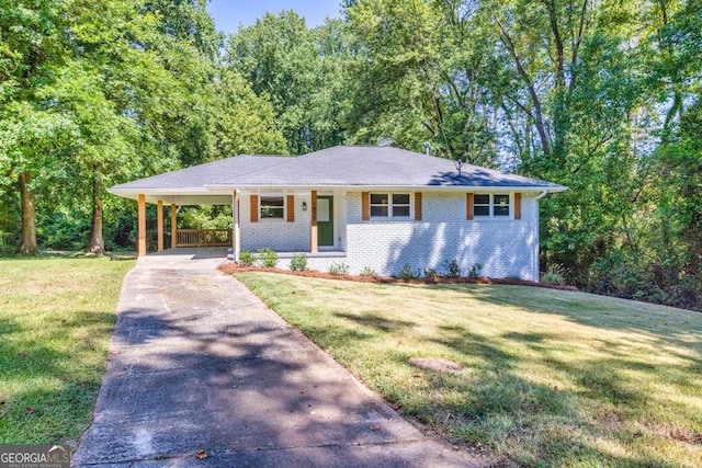 view of front of property with a carport, concrete driveway, a front yard, and brick siding