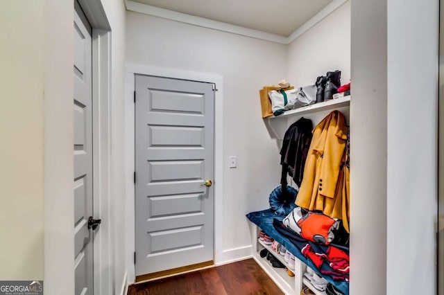 mudroom featuring crown molding, dark wood-type flooring, and baseboards