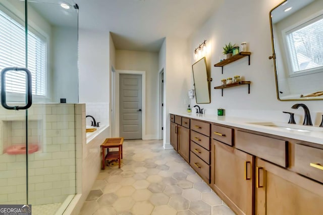 bathroom featuring double vanity, tile patterned flooring, a bath, and a sink