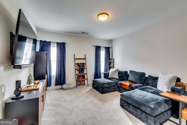 carpeted living room with visible vents and baseboards